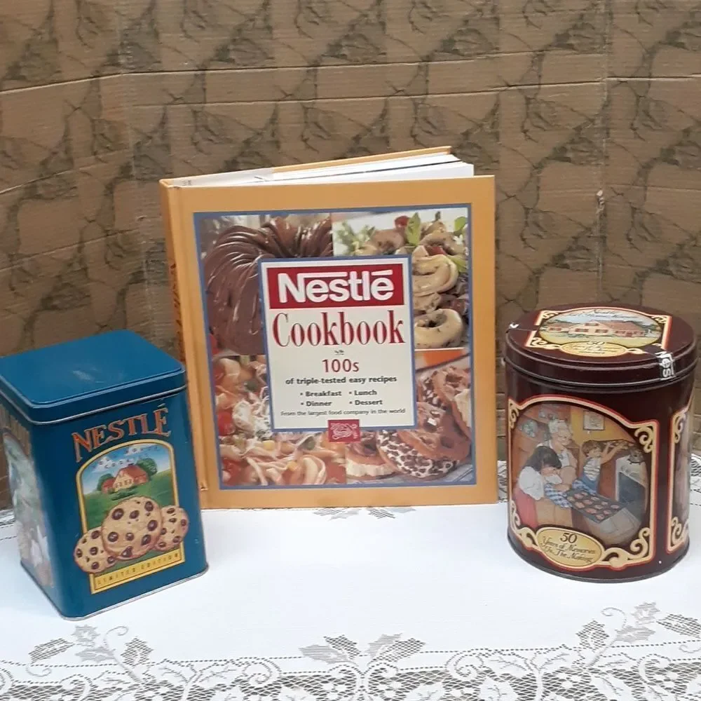 3-pc. Nestle's chocolate bundle: 2 vintage‎ tins and a hardcover cookbook